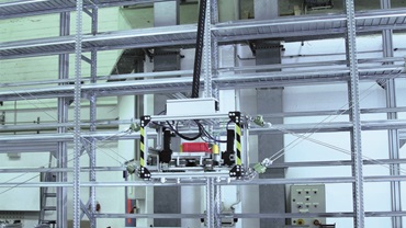 Robot à câbles dans un entrepôt à hauts rayonnages