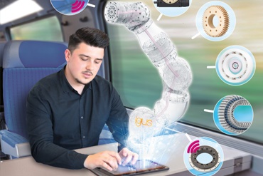 Un hombre trabaja con una tablet en el tren y anima un brazo robótico